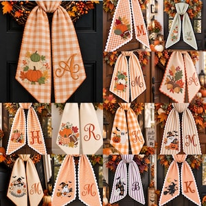 May include: A collection of decorative fabric door hangers featuring various seasonal embroidery designs including pumpkins, ghosts, witches, and footballs, paired with embroidered monogram letters on gingham, striped, or solid fabric panels.