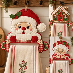May include: A set of three decorative felt towel holders featuring embroidered designs of Santa Claus, a gingerbread house, and Mrs. Claus. Each holder includes a cream-colored kitchen towel with red stripes and a green holly berry sprig.