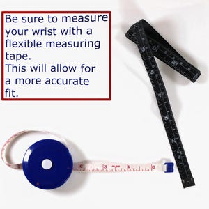 May include: Two measuring tapes, one black and one white with a blue case, are shown on a white surface. The text "Be sure to measure your wrist with a flexible measuring tape. This will allow for a more accurate fit." is displayed in a red box.