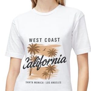 May include: White t-shirt with a graphic featuring palm trees and the text "West Coast California" above "Santa Monica - Los Angeles". The design includes brown and tan tones, with a small bird silhouette.