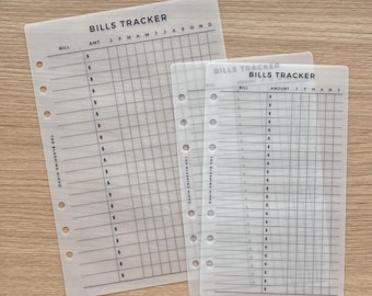 May include: Two translucent, punched planner inserts labeled BILLS TRACKER with columns for bill names, amounts, and months. The sheets feature black grid lines and dollar signs, with the text THE BLUSHING HIPPO printed vertically along the left margin.