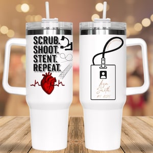 May include: Two white insulated tumblers with handles and straws. One features the text "SCRUB. SHOOT. STENT. REPEAT." with medical-themed graphics and a red heart. The other has a badge design with a name and ID number.
