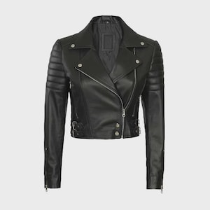 May include: Black leather motorcycle jacket with a notched collar, asymmetrical zipper closure, and quilted shoulder detailing. Features silver-tone hardware, including zippers on the sleeves and decorative buckles at the waist. A classic, edgy outerwear piece.