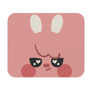 May include: A pink square mousepad featuring a cartoon pig face. The pig has white ears, black eyes with heart-shaped pupils, rosy cheeks, and a small snout. The design is simple and playful.