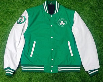 May include: Green and white varsity jacket with a green shamrock logo and the word "Celtics" on the front. The sleeves are white with green stripes at the cuffs.