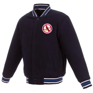 May include: Navy blue baseball-style jacket with a button-up front. The jacket features a white, blue, and navy striped collar, cuffs, and hem. A circular patch on the chest displays a red cardinal bird and the words "St. Louis Cardinals".