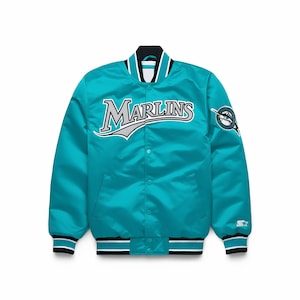 May include: Teal satin jacket with the word "Marlins" in white and gray across the chest. The jacket has a black, white, and teal striped collar, cuffs, and hem. A team logo patch is on the right sleeve.