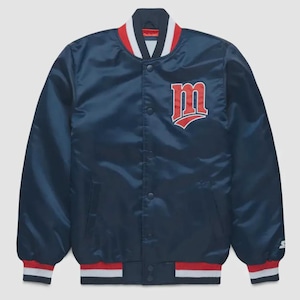 May include: A navy blue satin bomber jacket with a red and white striped collar and cuffs. The jacket features a large red "M" logo on the chest. The jacket has a button-up front and a Starter logo on the sleeve.