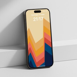 May include: A black smartphone with a colorful abstract wallpaper featuring a geometric design in shades of orange, red, and blue. The screen displays the date and time. The phone is leaning against a white surface.