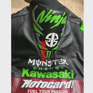 May include: Black motorcycle jacket with green and white "Ninja" logo on the back. The jacket also features "Monster Energy", "Kawasaki", and "Motocard" branding in white and green.