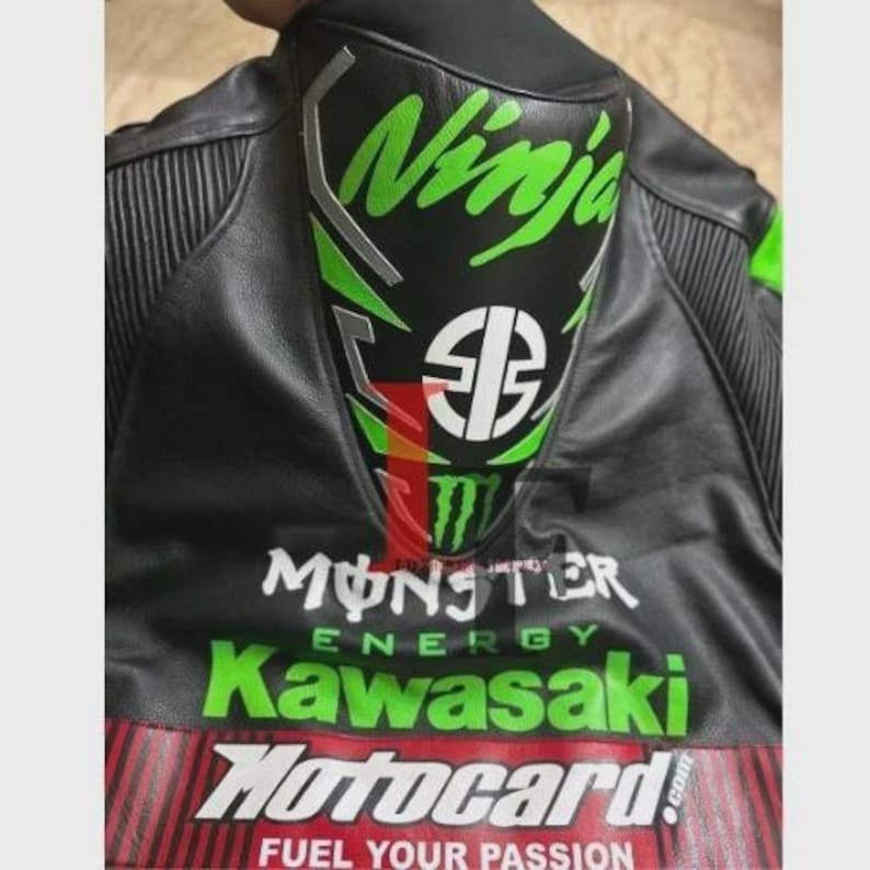 May include: Black motorcycle jacket with green and white "Ninja" logo on the back. The jacket also features "Monster Energy", "Kawasaki", and "Motocard" branding in white and green.