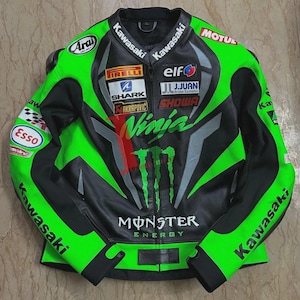 May include: A black and green Kawasaki Ninja motorcycle racing jacket. The jacket features multiple sponsor logos, including Monster Energy, Pirelli, and Elf. The jacket has a zip-up front and is made of leather.
