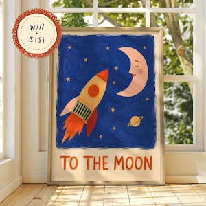 May include: A framed art print featuring a painted night sky with a rocket ship, a smiling crescent moon, and a small planet. The text "TO THE MOON" is printed in orange at the bottom. A circular logo in the top left corner reads "Will & Sisi".