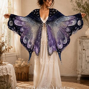 May include: A crochet shawl featuring a butterfly wing pattern in shades of dark blue, purple, and light lavender. The garment has an intricate openwork design with scalloped edges and a central closure. Text at the bottom reads Nature Inspired Fashion Soft Hook Studio.