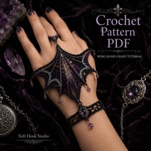 May include: A black and purple crocheted hand chain featuring a wing-shaped design with small dangling purple beads, connected to a matching wrist cuff with a central purple stone. Text reads: Crochet Pattern PDF, Wing Hand Chain Tutorial.