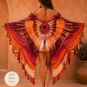 May include: A crochet shawl featuring a circular center design with radiating patterns in shades of deep purple, bright orange, and cream. The garment includes a halter neck tie, an open back, and a hemline finished with numerous hanging tassels.