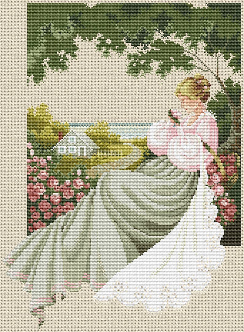 May include: Cross-stitch pattern of a woman in a pink dress and a long, flowing green skirt, seated in a garden. The scene includes a house, a path, and a profusion of pink roses. The image has a vintage, romantic aesthetic.