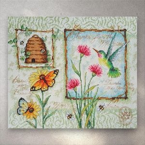 May include: Cross-stitch artwork depicting a beehive, flowers, butterflies, and a hummingbird. The artwork includes the text "Thanks for the Morning" and "Praise for Beauty". The color palette includes green, brown, yellow, pink, and blue.