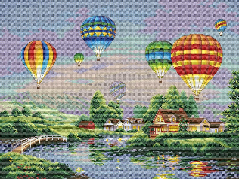 Puede incluir: Paisaje de punto de cruz con globos aerost&aacute;ticos de colores sobre un lago y un pueblo. Los globos son rojos, amarillos, azules y verdes. Un puente blanco cruza el agua, el cielo es de colores pastel.