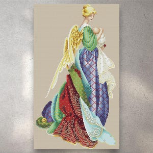 May include: Cross-stitch image of an angel cradling a baby. The angel has blonde hair, gold wings, and a gown in green, blue, and red patterns. The baby is wrapped in white cloth. The background is a light beige colour.