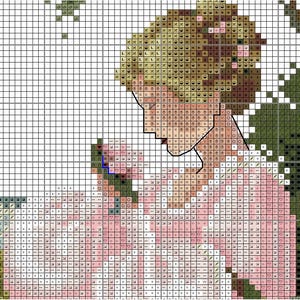 May include: Cross-stitch pattern featuring a woman in a pink dress, holding a flower. The design uses a grid of squares to create the image, with shades of pink, green, and brown. The woman's hair is blonde, and the background is a mix of white and green.