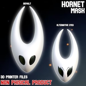 Peut inclure: Deux masques blancs Hornet avec des détails d'yeux noirs sont présentés sur un fond sombre. Le texte "HORNET MASK" est en haut, et "DEFAULT" et "ALTERNATIVE EYES" sont étiquetés au-dessus de chaque masque. Le texte inférieur indique "3D PRINTER FILES NON PHISICAL PRODUCT".