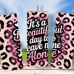 May include: Pink leopard print tumbler with the text "It's a beautiful day to leave me alone." The tumbler has a silver straw and lid. The design includes black leopard spots, pink glitter, and hearts. A fun and stylish accessory.