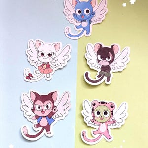 May include: Five cartoon stickers of winged cat-like characters in different colours. The stickers have white wings and are set against a light blue and yellow-green background. Each character has a unique outfit and expression.