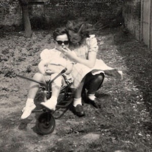 Foto d'epoca - Ragazza che allatta un bambino