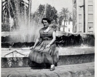 Vintage Black & White Photo - Woman Sat in Front of a Fountain