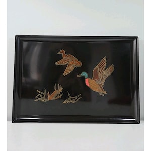 May include: A rectangular black tray with a glossy finish. The tray features an inlaid design of two ducks in flight and one duck on the ground, with detailed brown and gold accents. The ducks have colorful details.