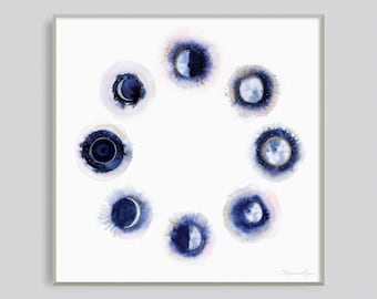 May include: A watercolor painting of the phases of the moon in a circle. The moon is depicted in shades of blue and gold on a white background.