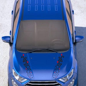 May include: Overhead view of a blue car with black and red diamond-shaped decals on the hood. The car has a sunroof and side mirrors. The car's headlights and grill are visible.