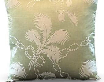 May include: Square decorative pillow with a light green background and a white, repeating pattern of stylized feathers and beaded accents. The pillow has a soft, textured appearance and a classic design.