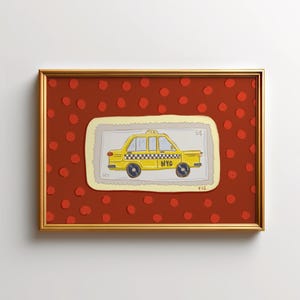 May include: A framed artwork featuring a yellow taxi cab illustration. The taxi is depicted on a postage stamp-like design with the letters "NYC". The background is a red surface with evenly spaced red polka dots, all within a gold frame.