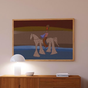 May include: A framed artwork depicts a rider on a horse in a stylized, folk art style. The artwork features a color palette of browns, blues, and reds. The artwork is displayed above a mid-century modern wooden cabinet with a white lamp and bowl.