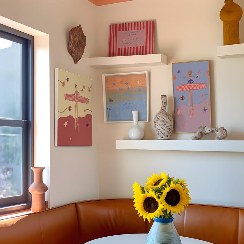 May include: An interior shot featuring a corner with artwork, shelves, and a leather bench. The artwork includes framed prints with abstract and figurative designs. A vase of sunflowers sits on a table. Decorative vases and a window are also visible.