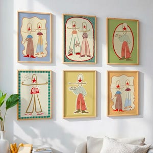 May include: Six framed art prints with whimsical illustrations of figures wearing hats and outfits in various colors. The prints are in wooden frames and hang on a white wall. A green plant in a white vase is in the foreground.