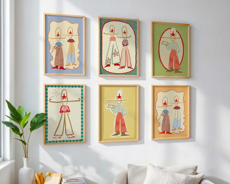 May include: Six framed art prints with whimsical illustrations of figures wearing hats and outfits in various colors. The prints are in wooden frames and hang on a white wall. A green plant in a white vase is in the foreground.