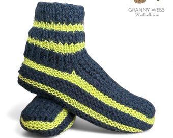 May include: A pair of hand-knitted ankle socks featuring a dark navy blue base with horizontal neon yellow stripes. The socks have a ribbed cuff and a textured knit pattern. The logo GRANNY WEBS Knit with care is visible.