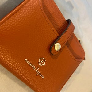 Nanette Lepore Bi-fold Open Wallet With Latch And Tassoe