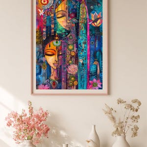 May include: A framed art print depicting a colourful, abstract portrait of two women with closed eyes. The artwork uses vibrant blues, pinks, and yellows, with floral and geometric patterns. The print is displayed above a white shelf with vases and decorative items.