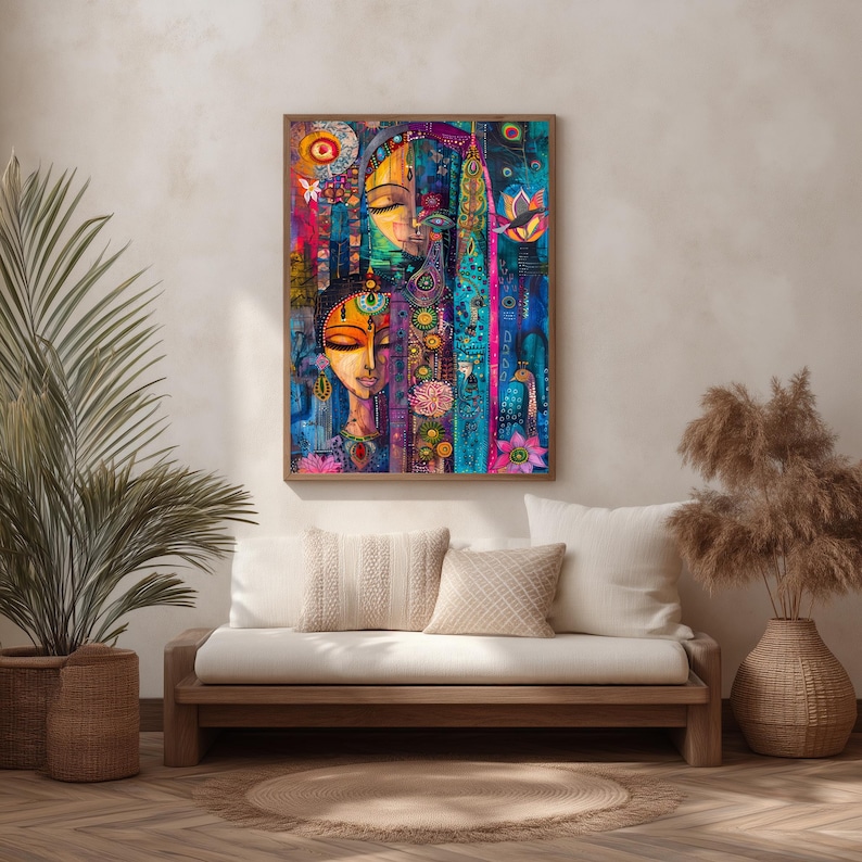 May include: A framed abstract painting with two stylized faces. The artwork uses blues, pinks, and yellows, with intricate patterns and floral motifs. The painting is displayed above a wooden sofa with white cushions. The painting is in a wooden frame.