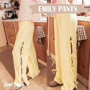 Op de afbeelding: Gele geruite broek met zijsplitten en strikken. De broek heeft de tekst "EMILY PANTS" in een banner bovenaan. De broek maakt deel uit van een pyjamaset. Het Angel Sewing Patterns-logo staat linksonder.