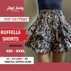 May include: Ruffled shorts with a leopard print pattern. The shorts have a tiered design and an elastic waistband. The image includes text that reads "RUFFELLA SHORTS" and "BEGINNER". The pattern is available in sizes XXS to XXXL.