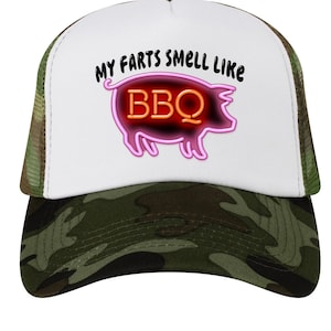 May include: A camouflage trucker hat with a white front panel featuring the text "MY FARTS SMELL LIKE BBQ" above a neon pink pig graphic with the letters "BBQ" in orange.