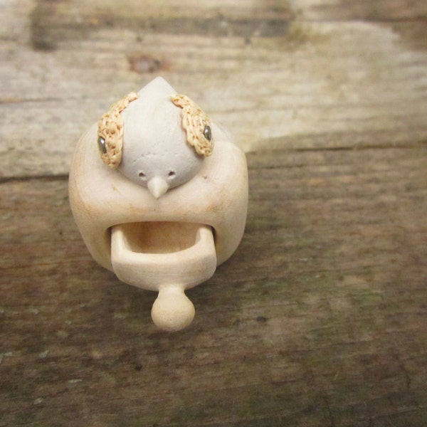 Miniature cabinet with a cute little bird, wood carving