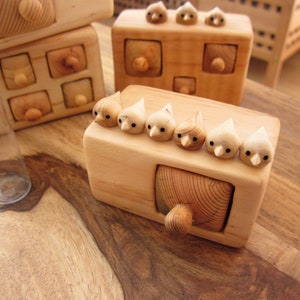 Small wooden box with one drawer and flock of six birds on the top. The miniature box, drawers and birds are hand carved from wood. The drawer can fit a rings or other small jewelry. A very sweet hand carved gift for a special ocasions.