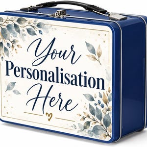 May include: A rectangular blue metal lunch box with a black plastic handle and a silver metal latch. The front panel features a white background with a botanical design of blue and gold leaves and the text Your Personalisation Here in blue.