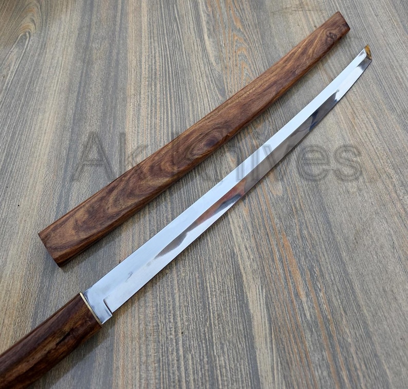 May include: A Japanese-style sword with a polished steel blade and a wooden handle and sheath. The handle and sheath are a dark brown colour with a wood grain pattern. The blade is straight and has a sharp edge.